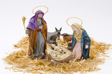 Christmas Crib. Figures of Baby Jesus, Virgin Mary and St. Joseph on white background.